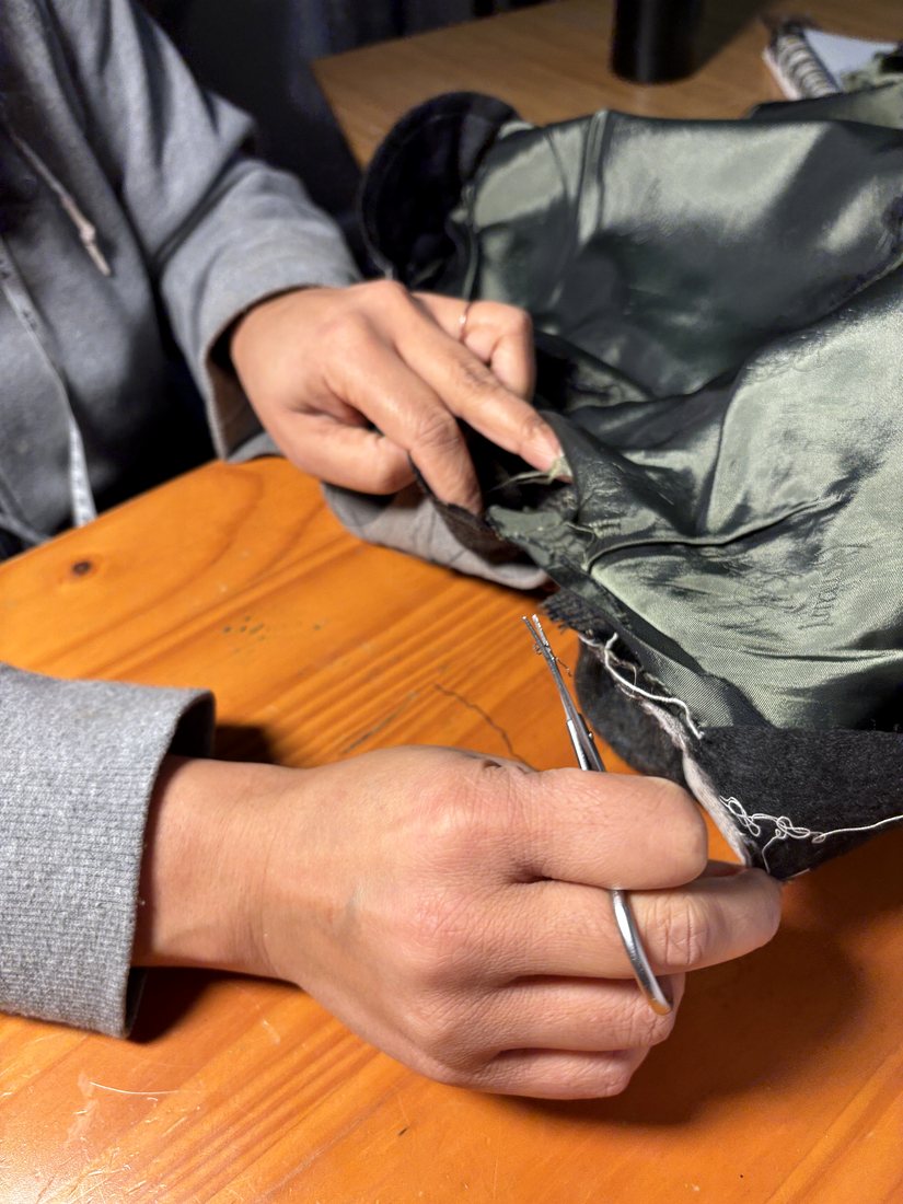 Repairing a jacket lining by hand